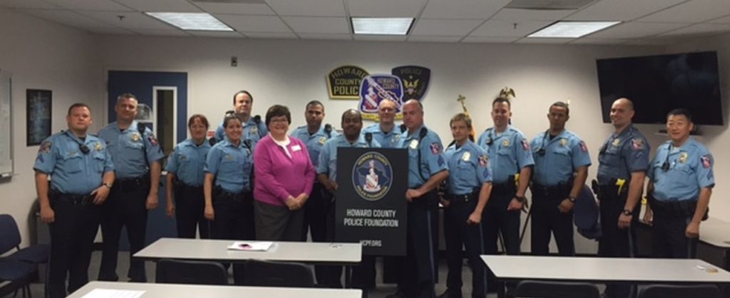 A group of people in police uniforms standing next to each other.