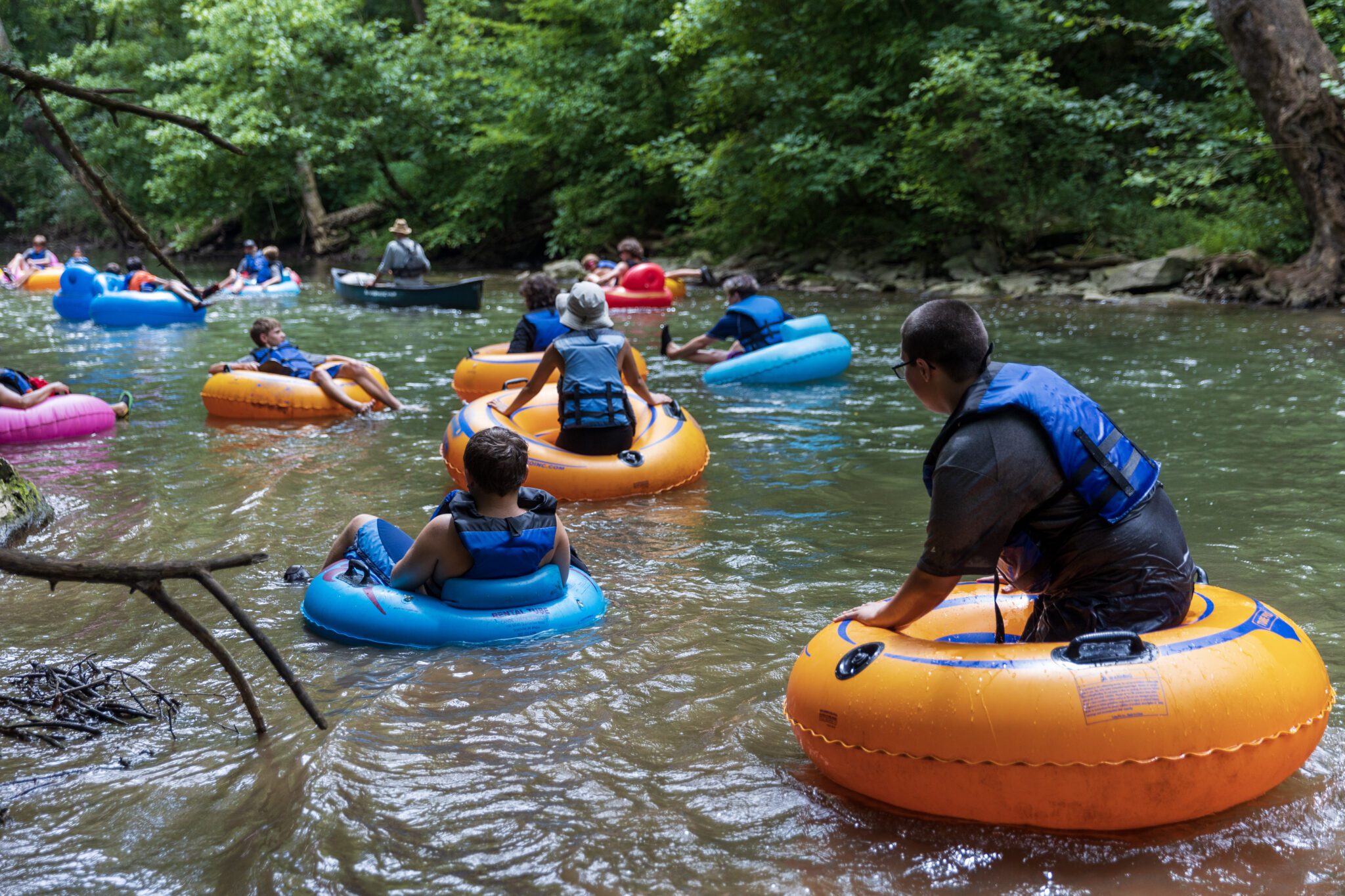 The participants of the P.L.E.D.G.E. Leadership Program embark on an exciting adventure, coming together as a group to float down a river on tubes.