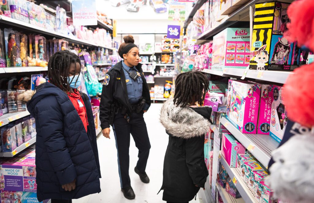 A group of children are shopping in a toy store as part of the Shop With A Cop program.