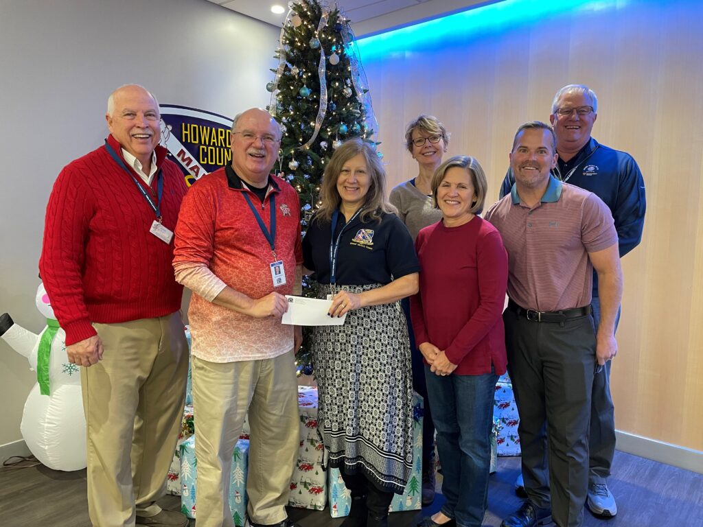 A group of people standing around each other.