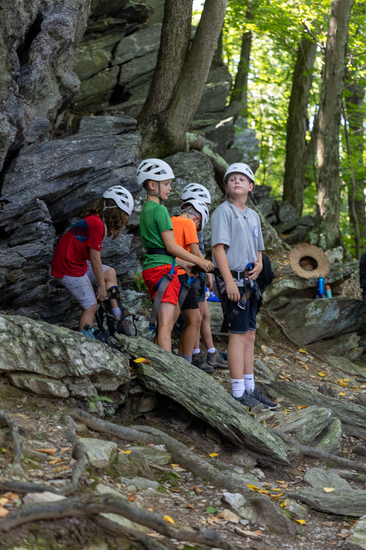A group of kids exploring BearTrax on a rock.