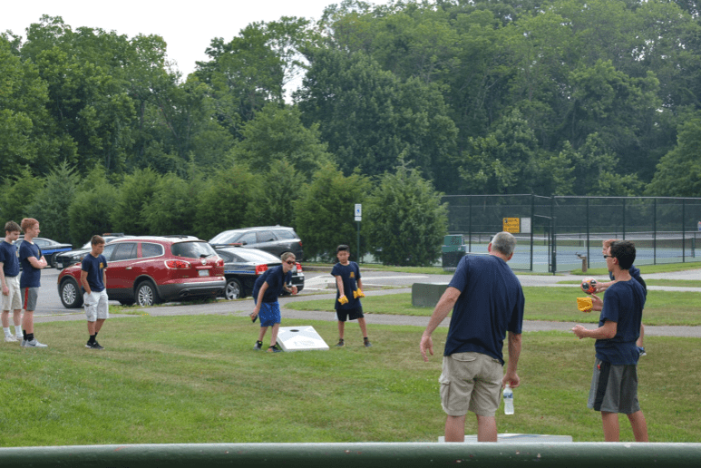 A group of people participating in the P.L.E.D.G.E. Leadership Program playing a game of frisbee.