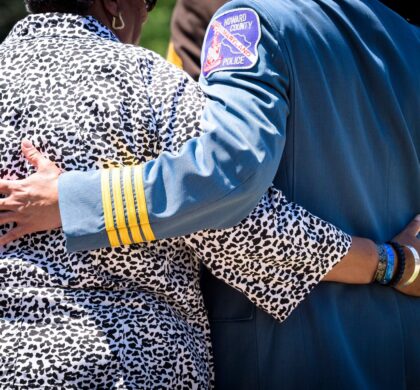 A man and woman hugging each other at the HCPD Memorial Garden ceremony.