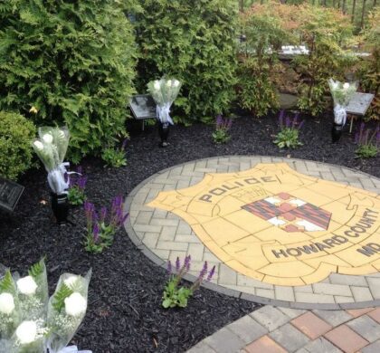 HCPD Memorial Garden is a serene tribute adorned with beautiful flowers and prominently featuring the police emblem.