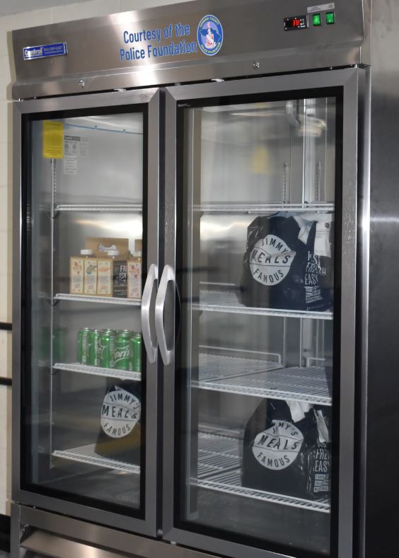 A stainless steel refrigerator with a glass door, suitable for HCPD equipment storage.