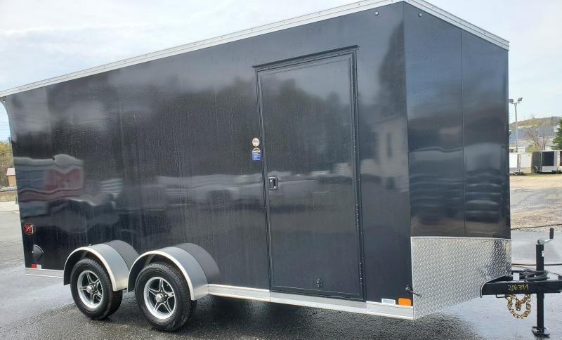 A black enclosed cargo trailer with HCPD Equipment in a parking lot.