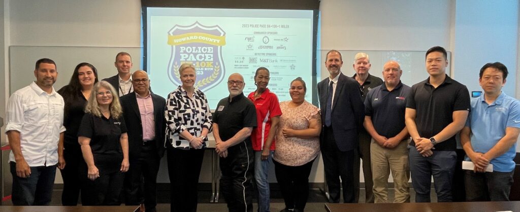 A group of people standing in front of a police pace sign.
