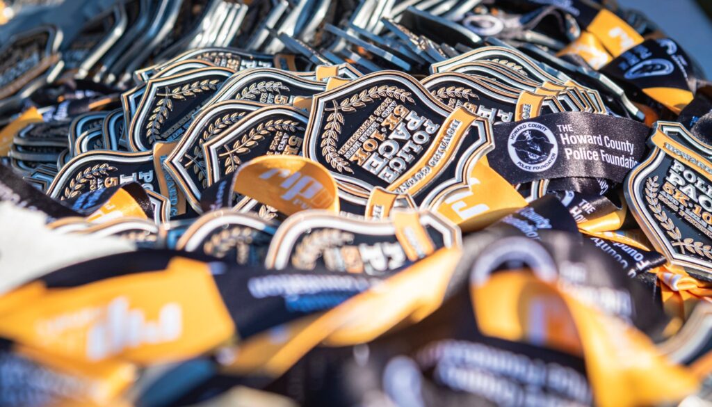 Close-up of embroidered police badges piled together.