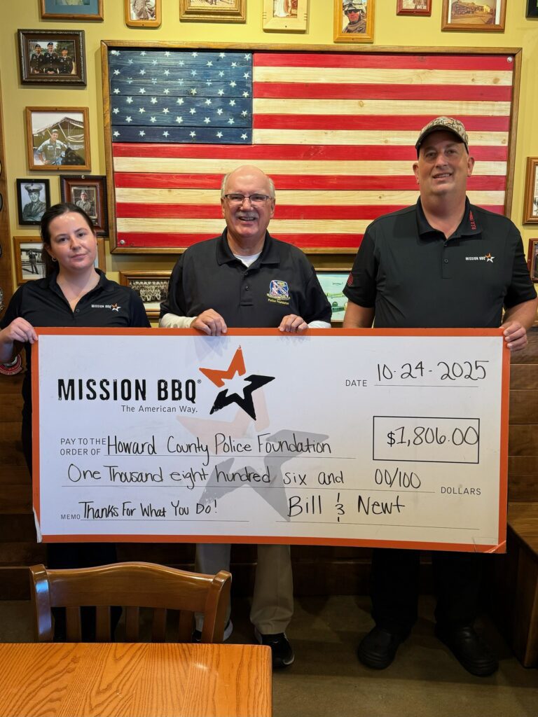 Three people holding a large check from Mission BBQ for $2000.